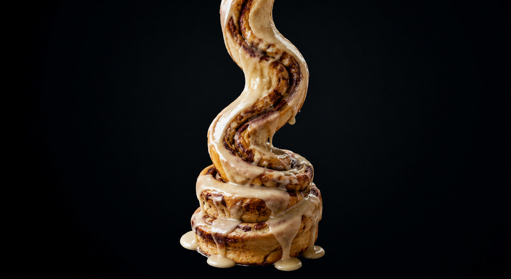 Tall glazed cinnamon roll with a glossy finish